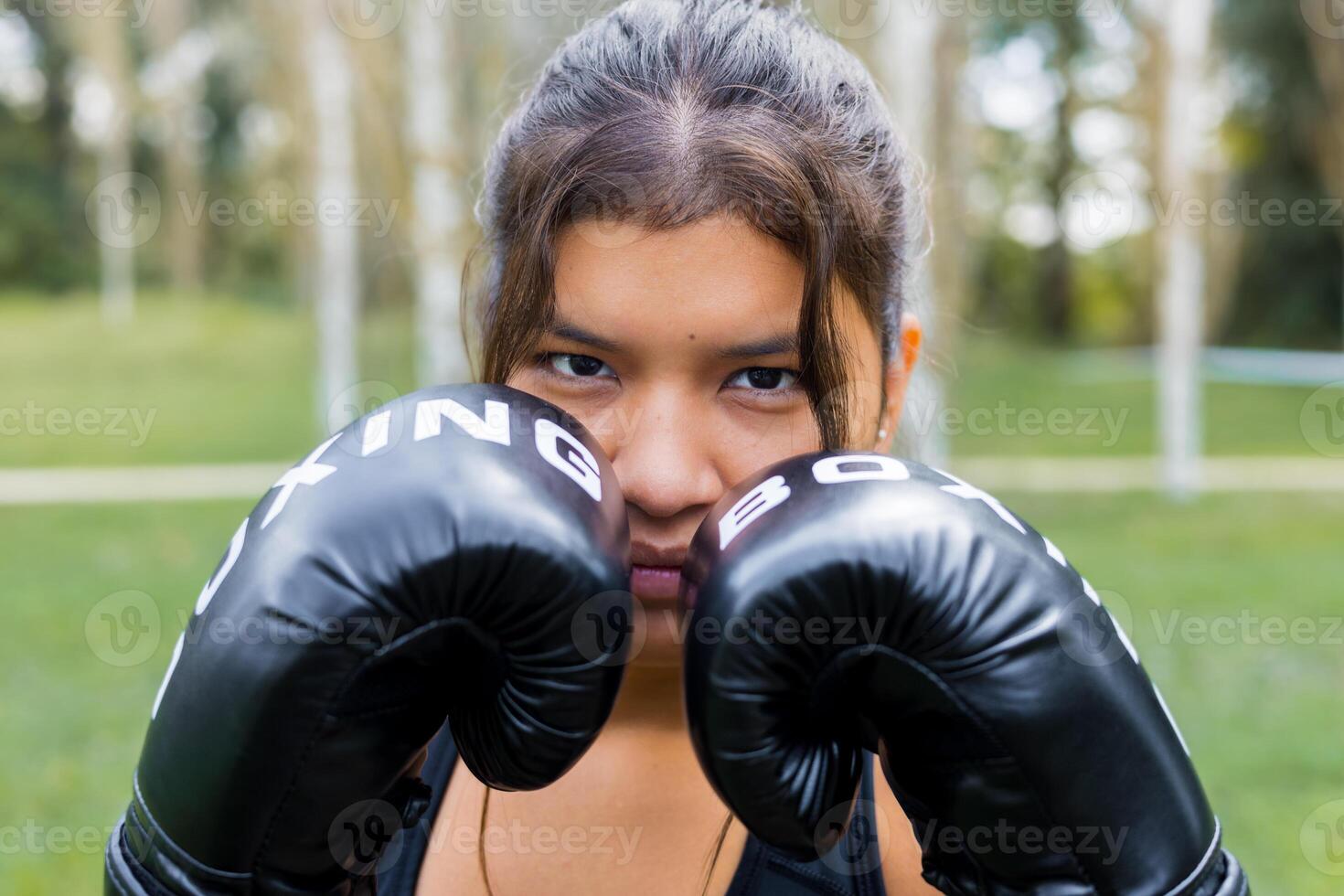 Boxer woman portrait wearing boxing gloves photo