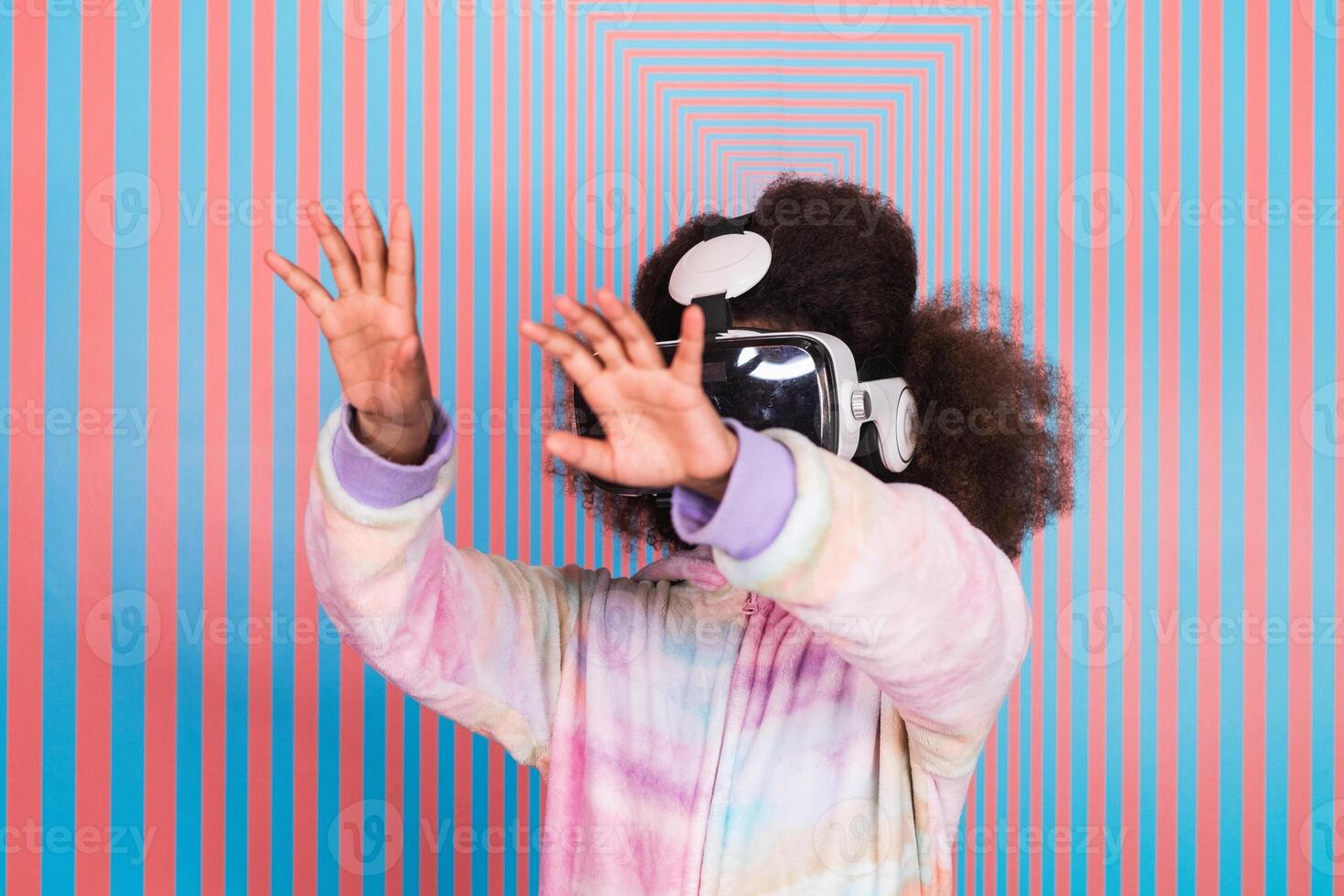 Black girl using VR goggles in studio photo