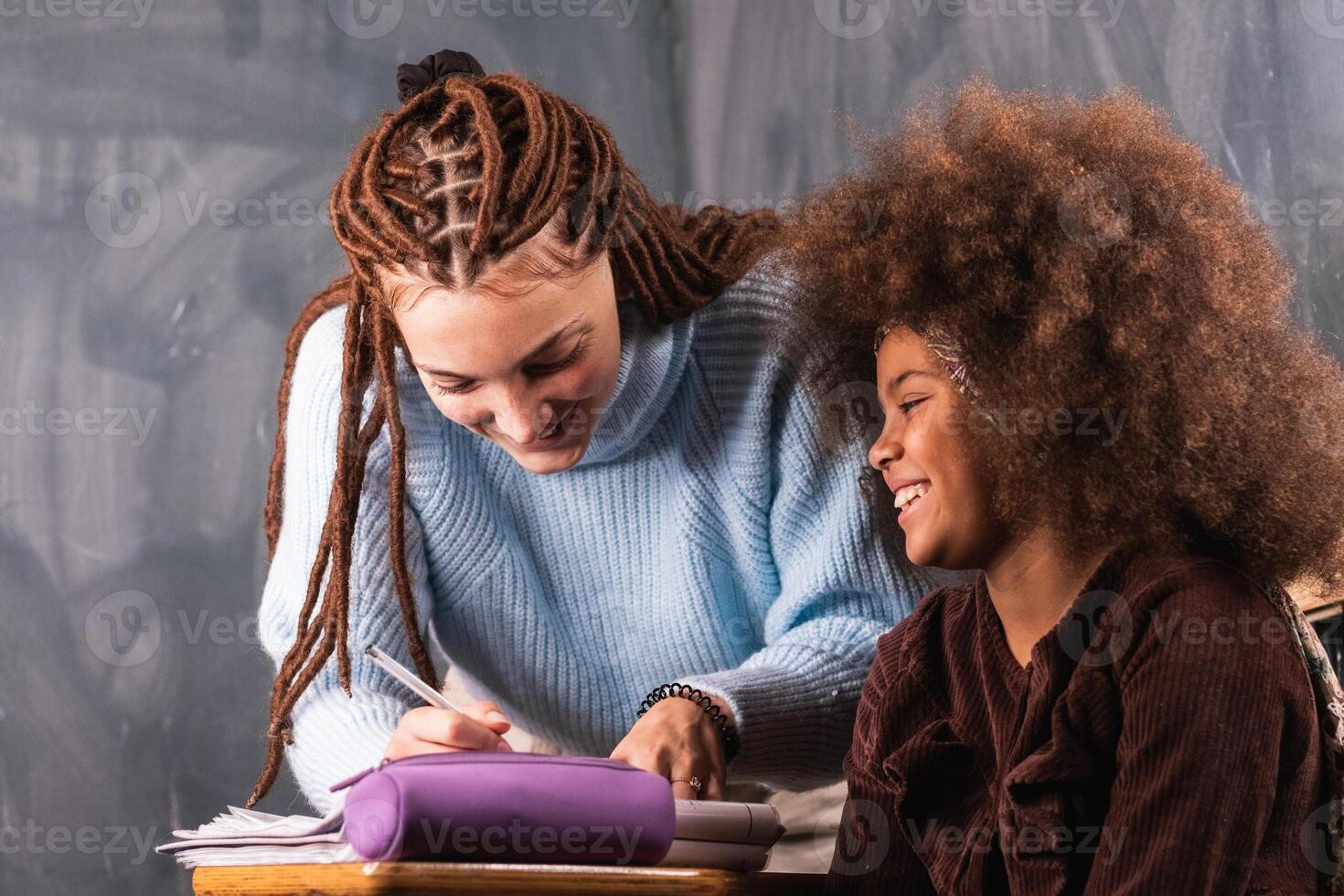 Black schoolgirl and teacher in classroom photo