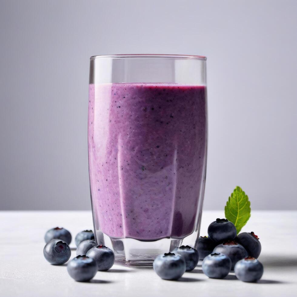 Glass of blueberry smoothie with fresh berries, copy space. Close-up food image for use in product design photo