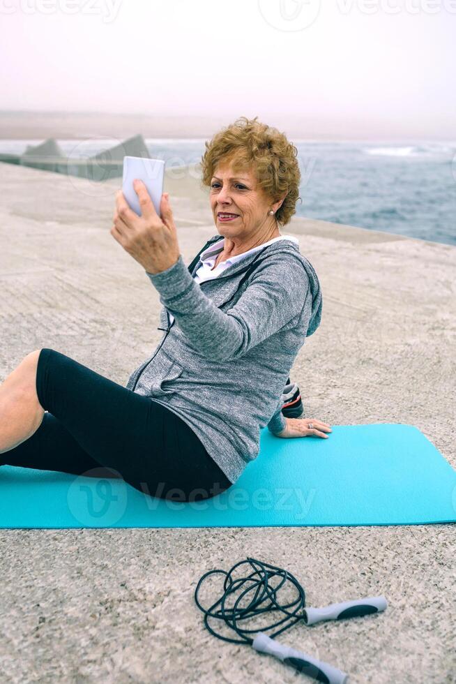 Senior sportswoman taking selfie photo