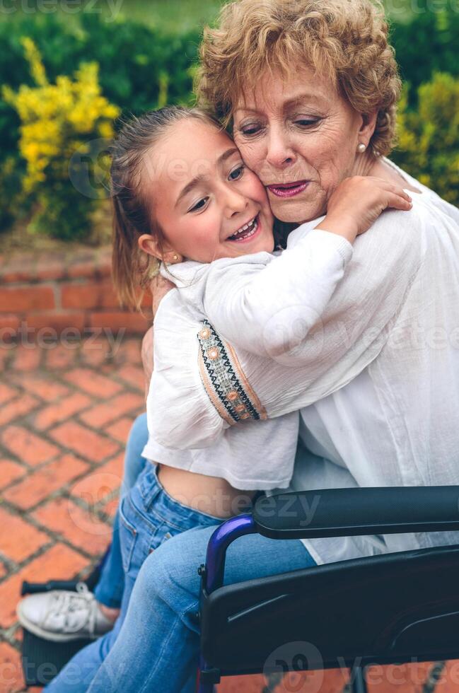 Granddaughter hugging her grandmother photo