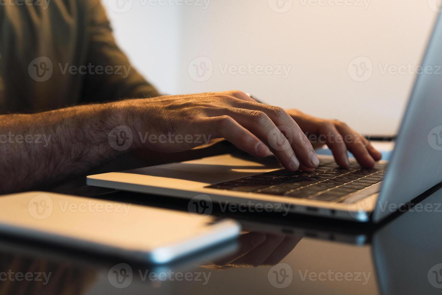 Faceless man typing on laptop photo