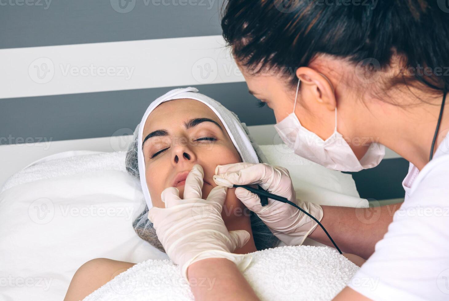 Woman getting rf lifting in her face in clinic photo