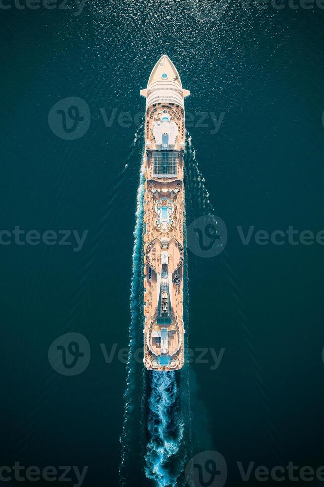 Huge cruise ship with a swimming pools floats on the sea. Top view photo