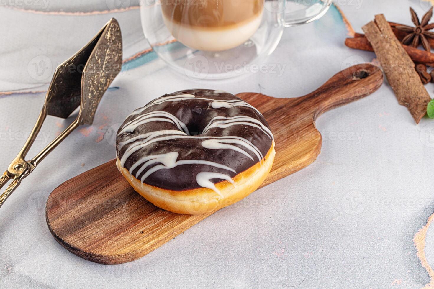 A donut on a wooden cutting board photo