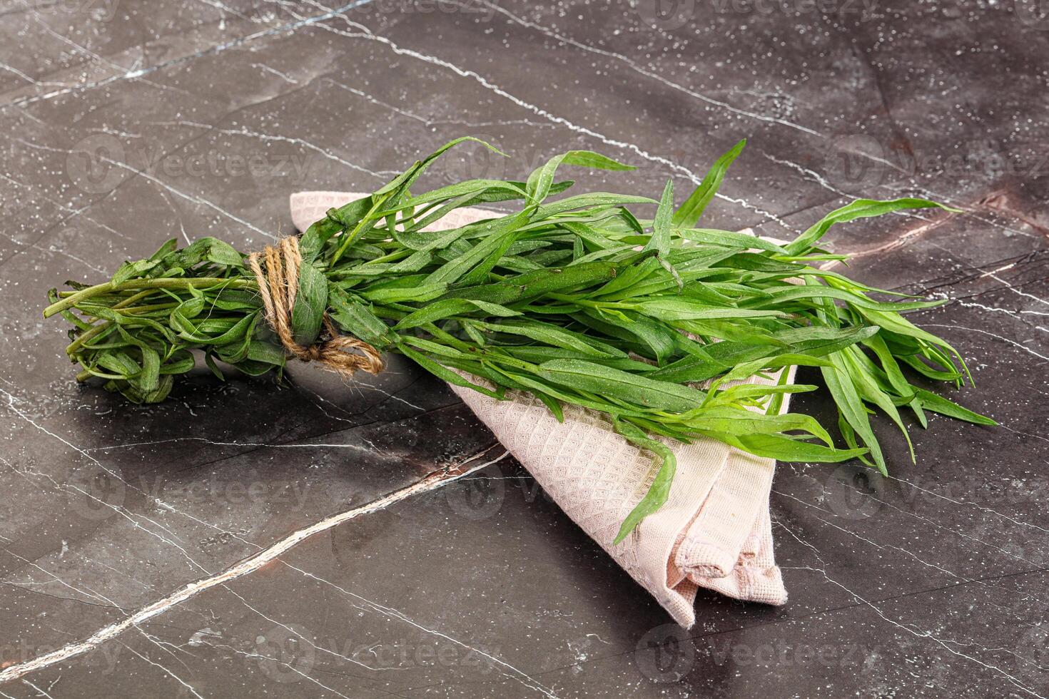 A bunch of herbs on a marble counter photo