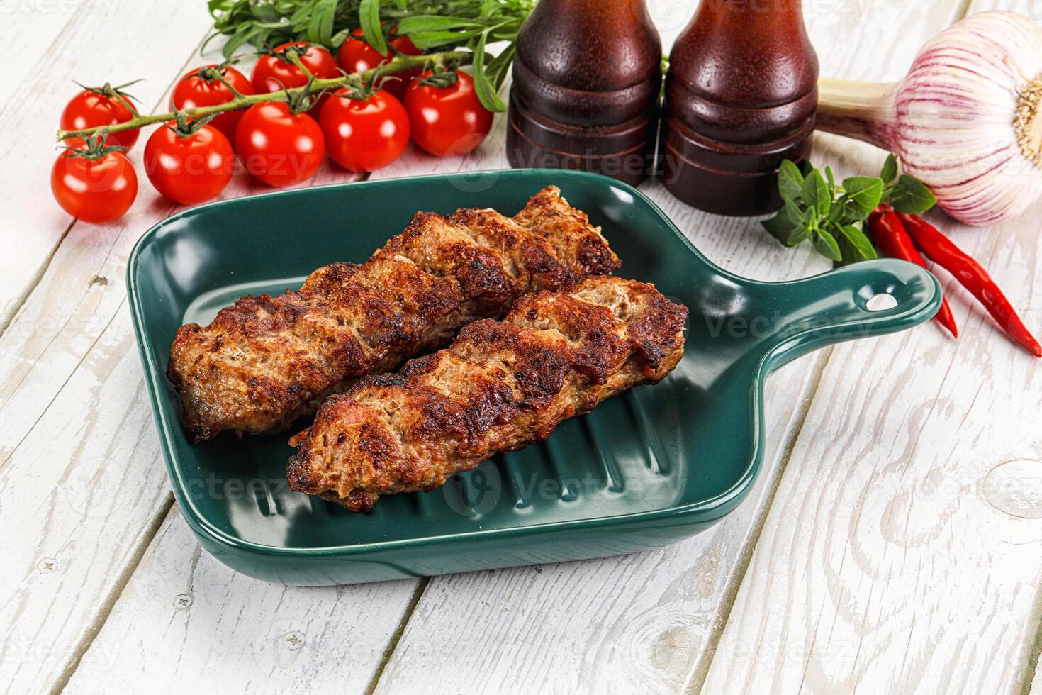 A green dish with two meatballs on it photo