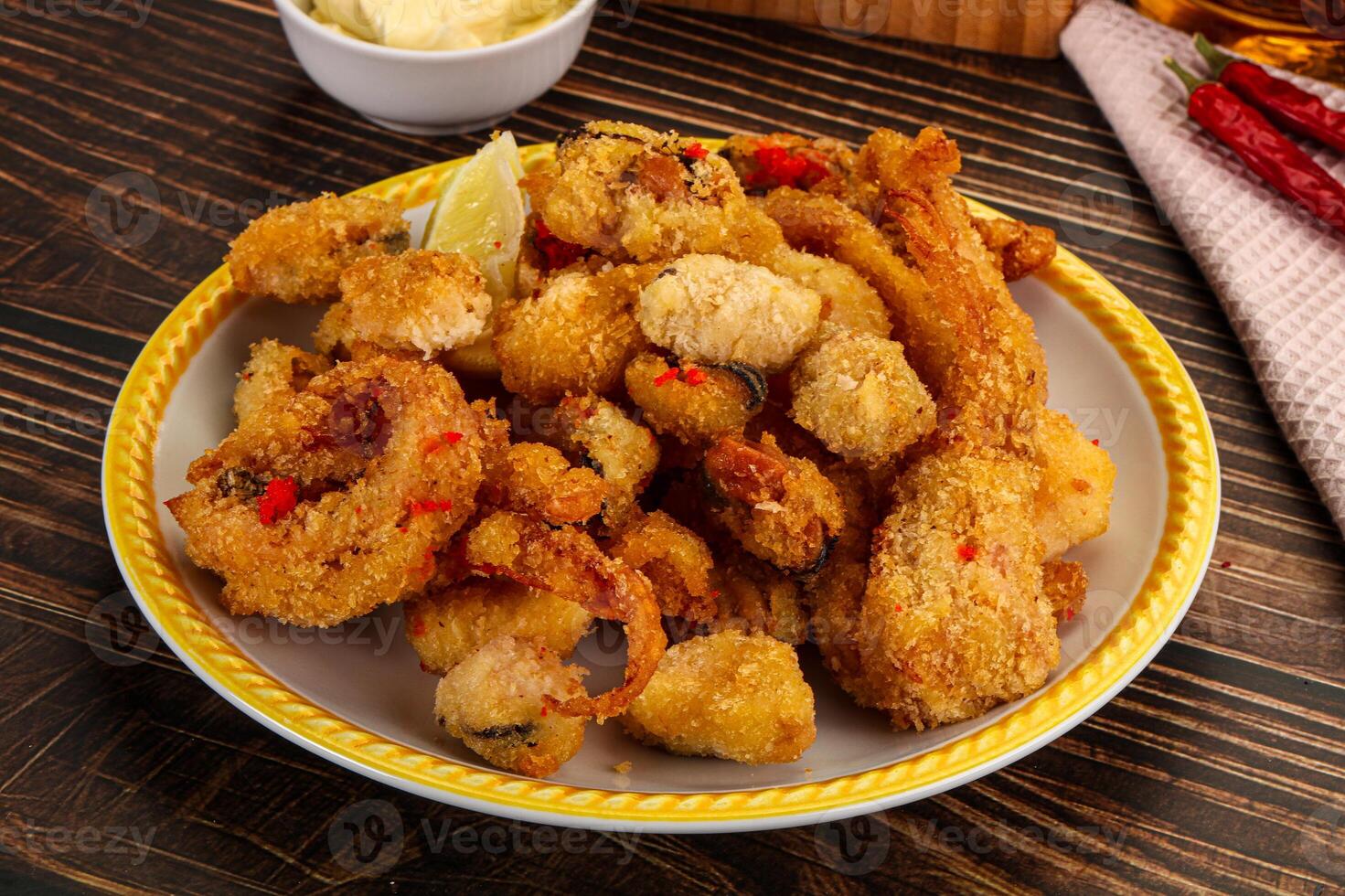 A plate of fried seafood on a wooden table photo