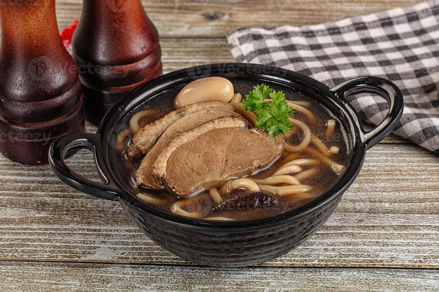 A bowl of noodles with meat and vegetables in it photo
