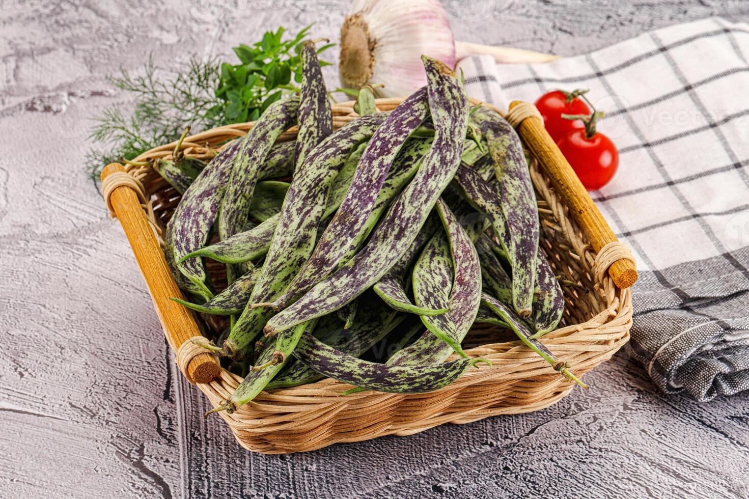 A basket filled with green beans and a tomato photo
