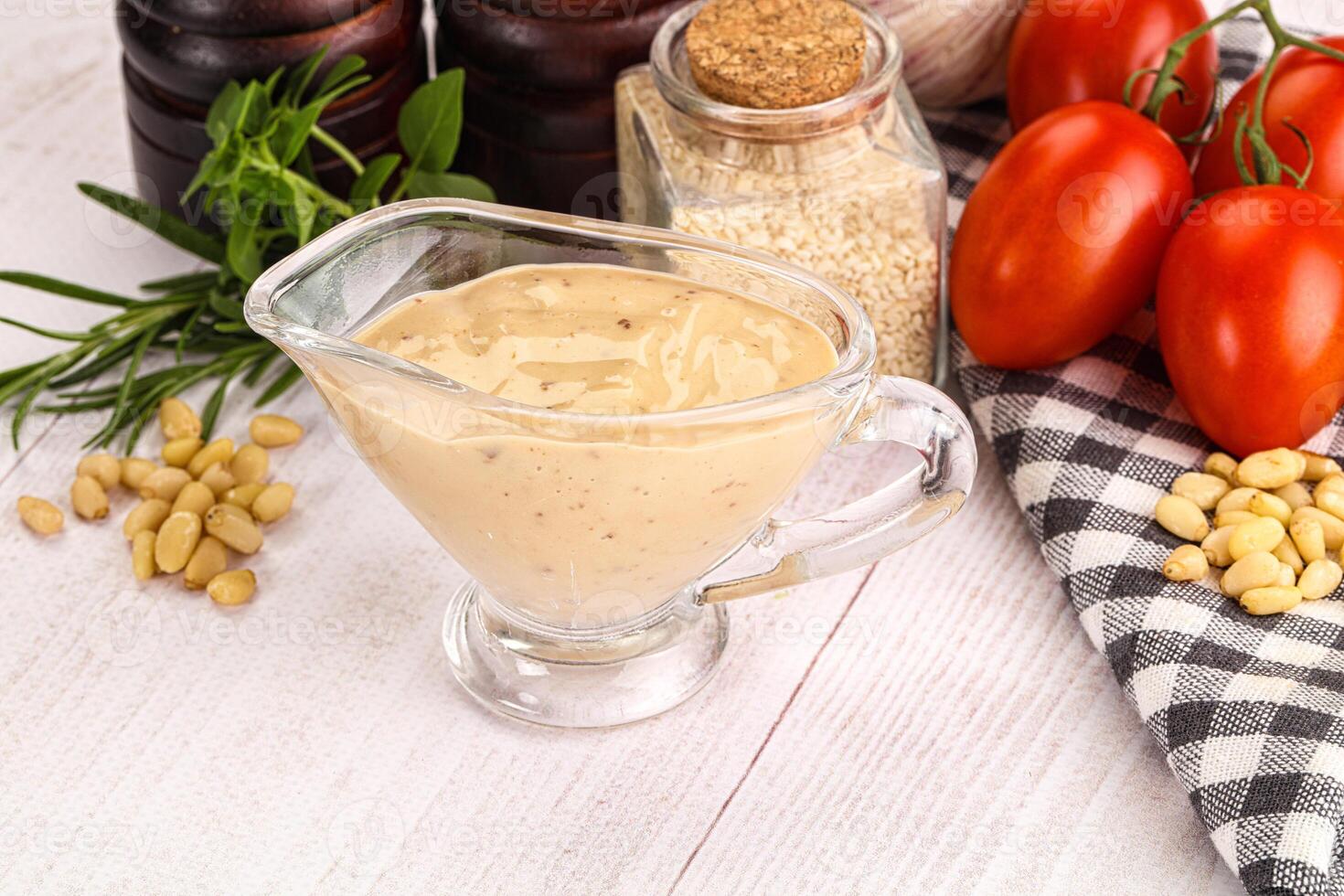 A glass pitcher filled with a creamy sauce photo