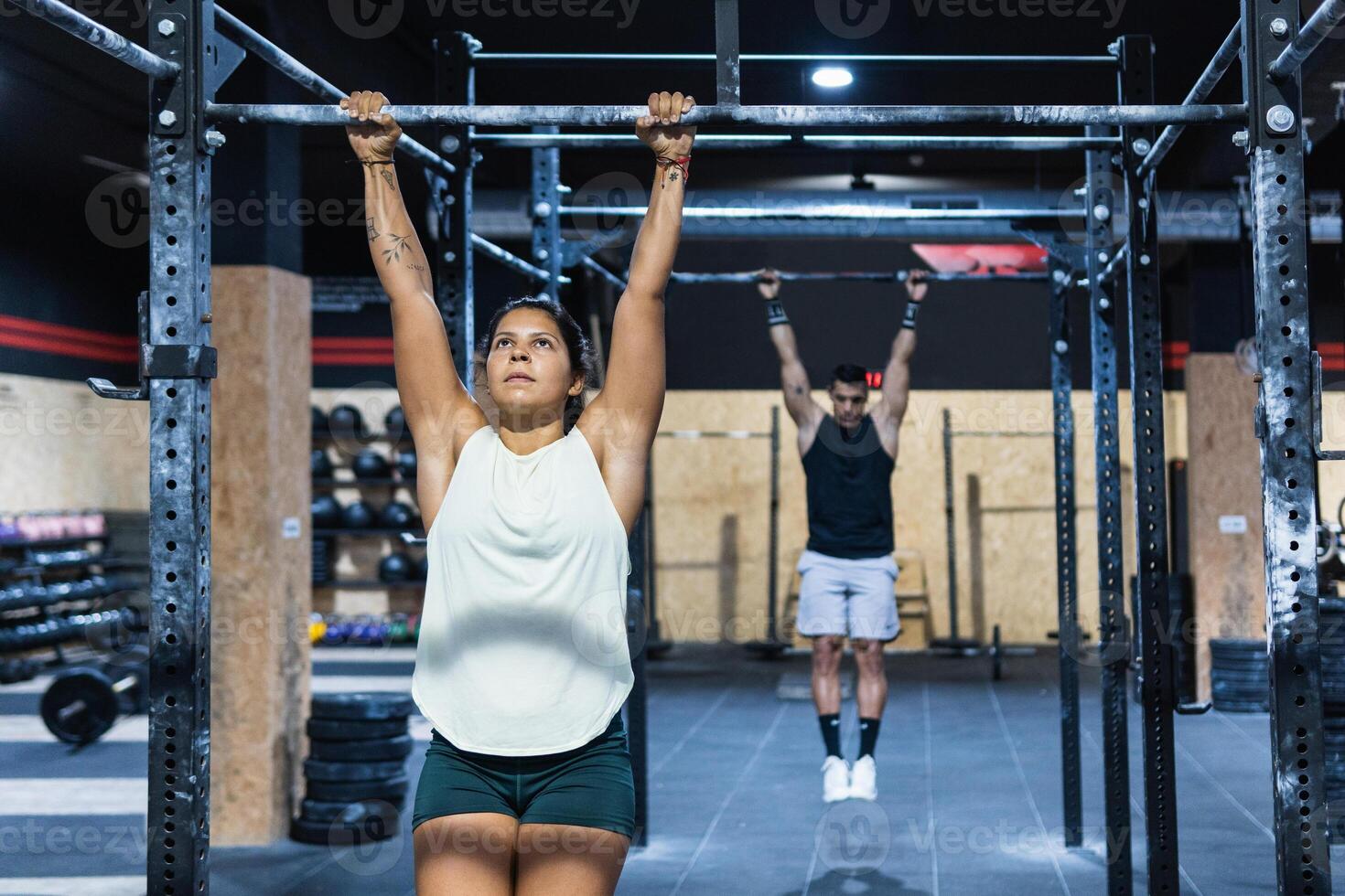 Sportive couple hanging on crossbars photo