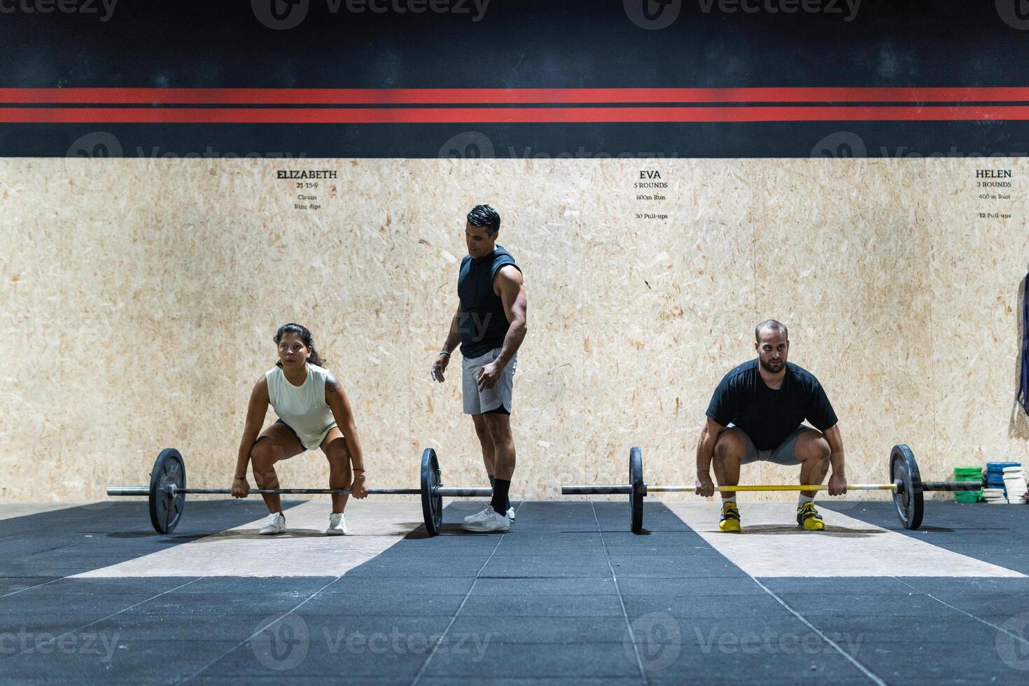 Hispanic sportspeople training with barbells photo