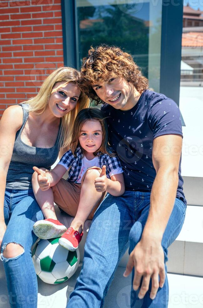 Parents and son in front of new home photo