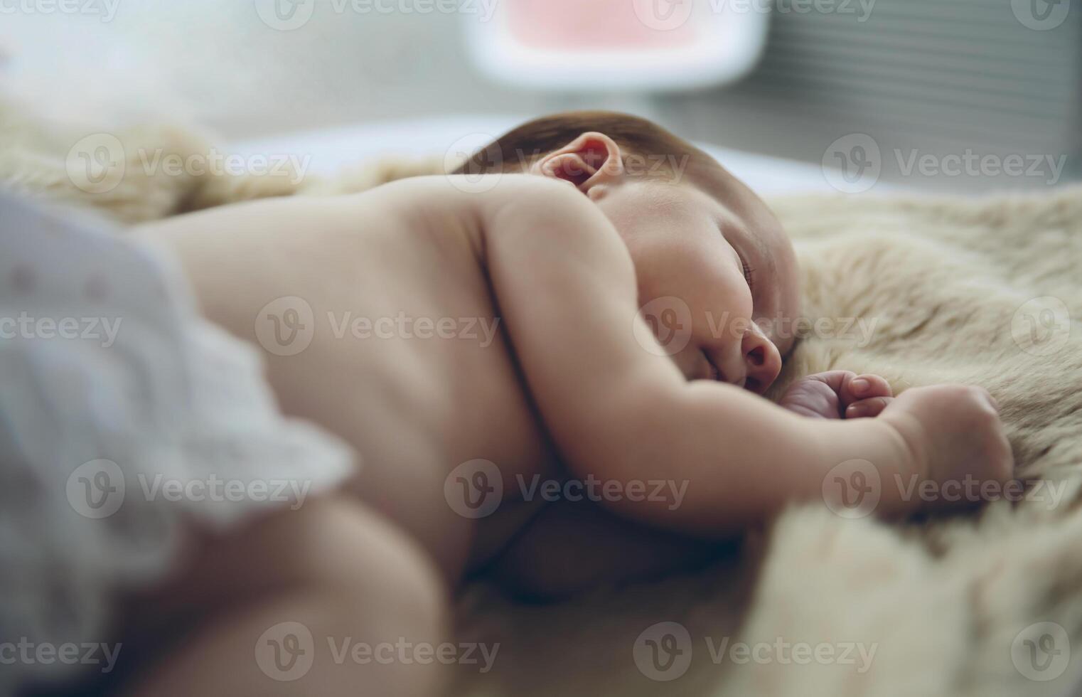 Baby sleeping on a blanket photo