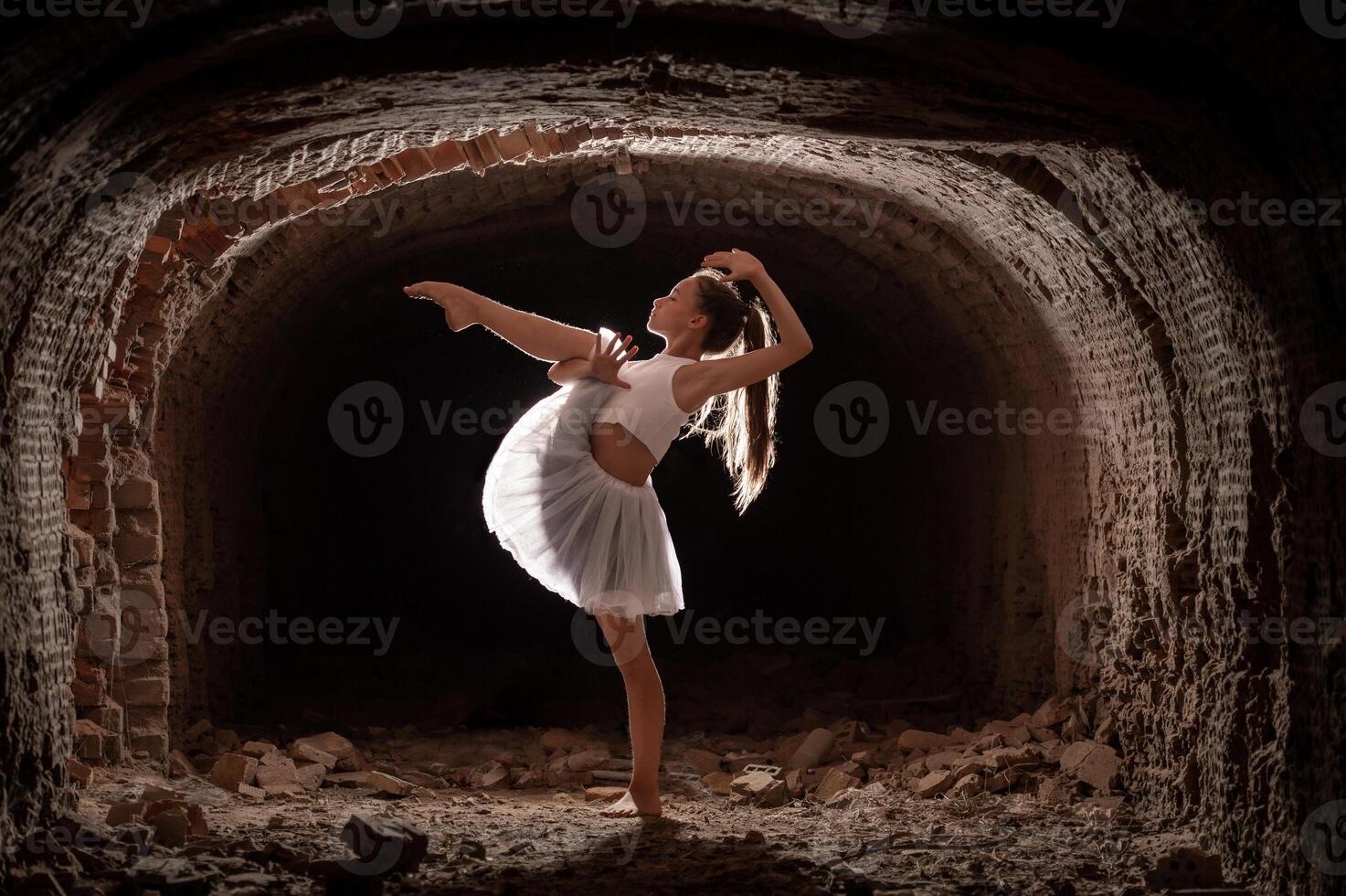 Young girl performing rhythmic gymnastics exercises outdoors photo