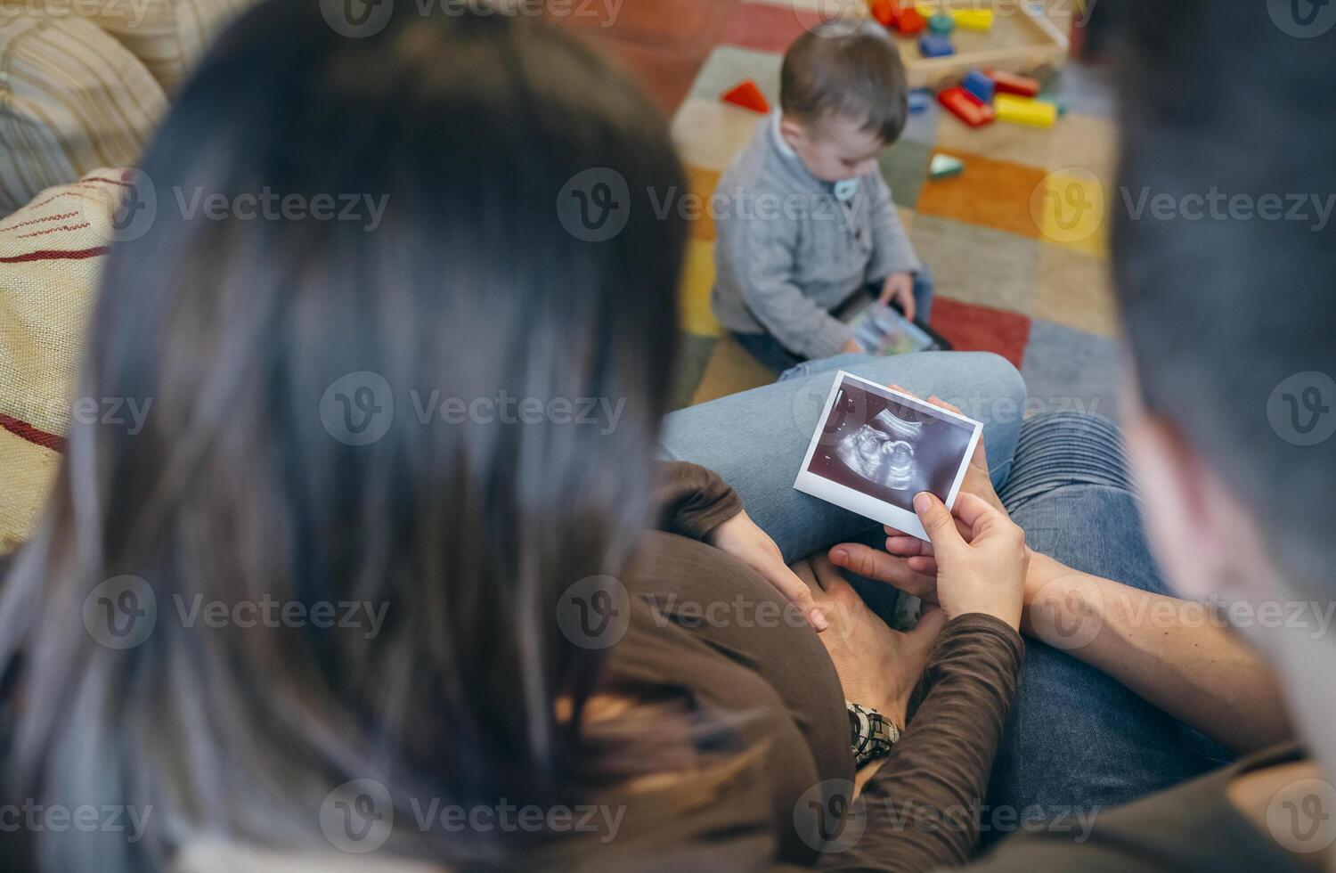 Parents looking ultrasound of their new baby photo