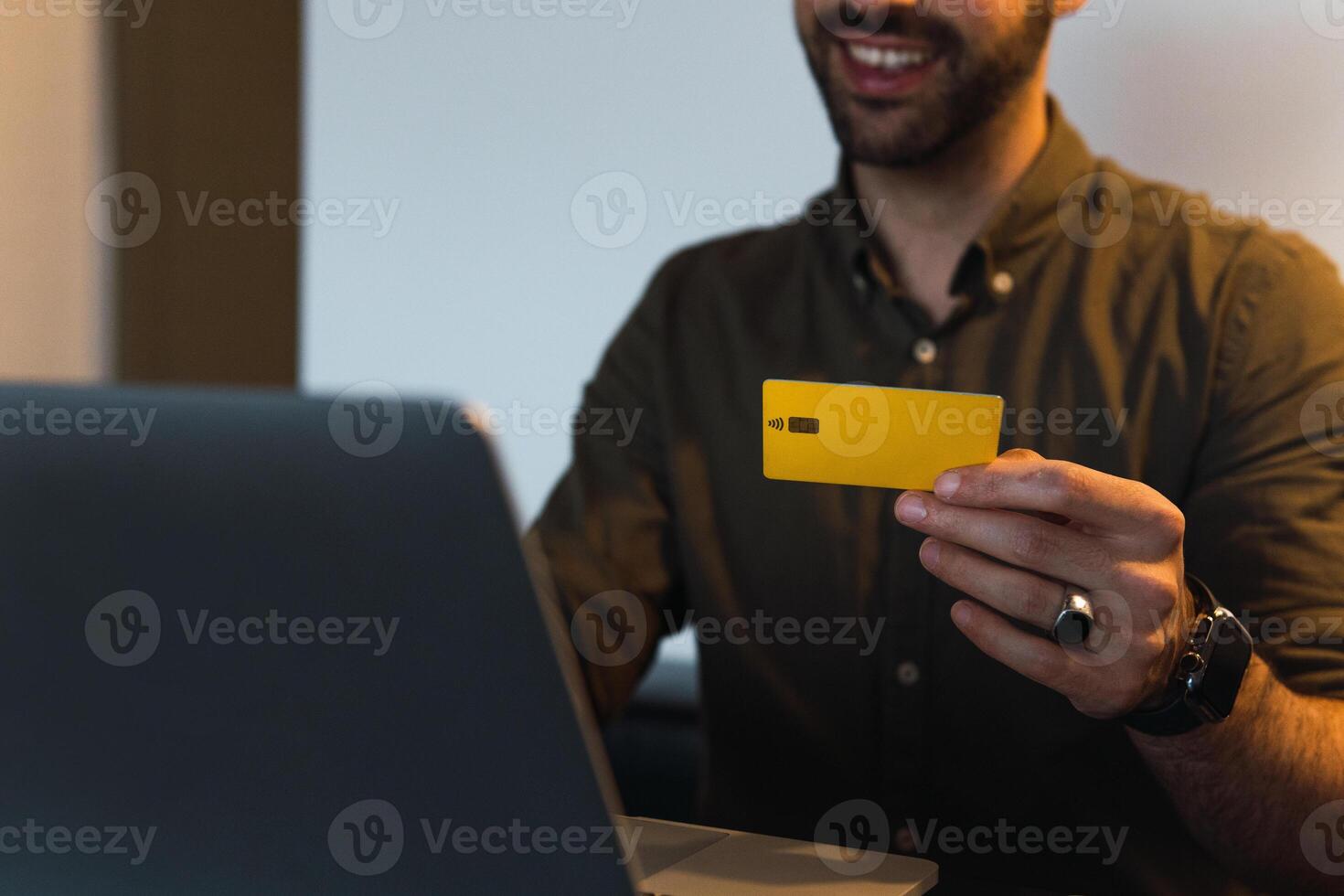 Anonymous man with credit card shopping online photo