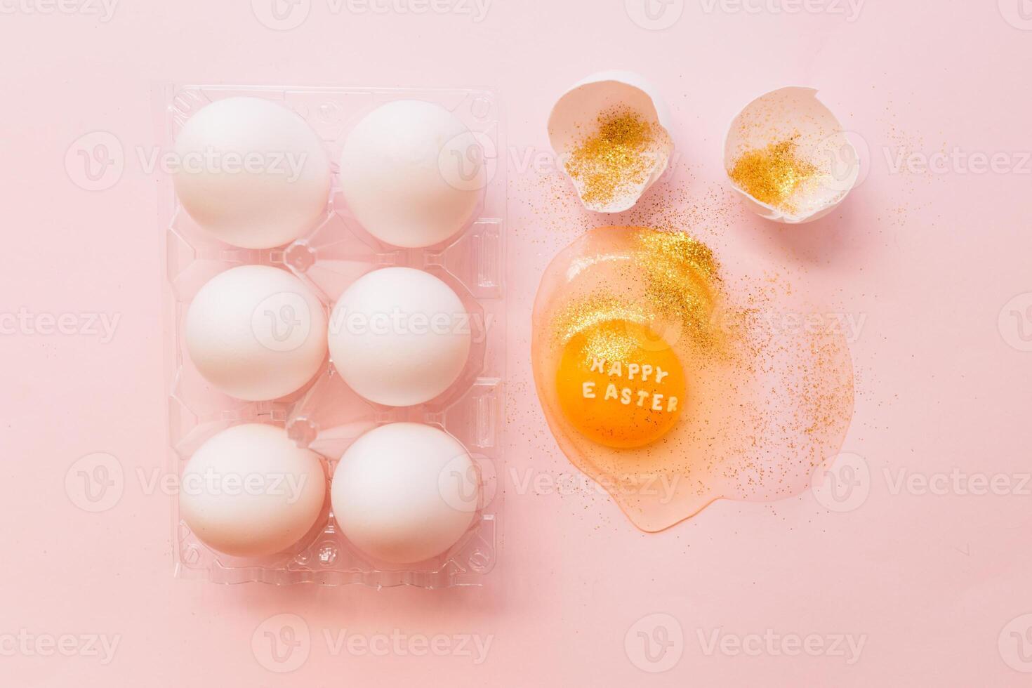 Festive Easter eggs in box and broken egg on table photo