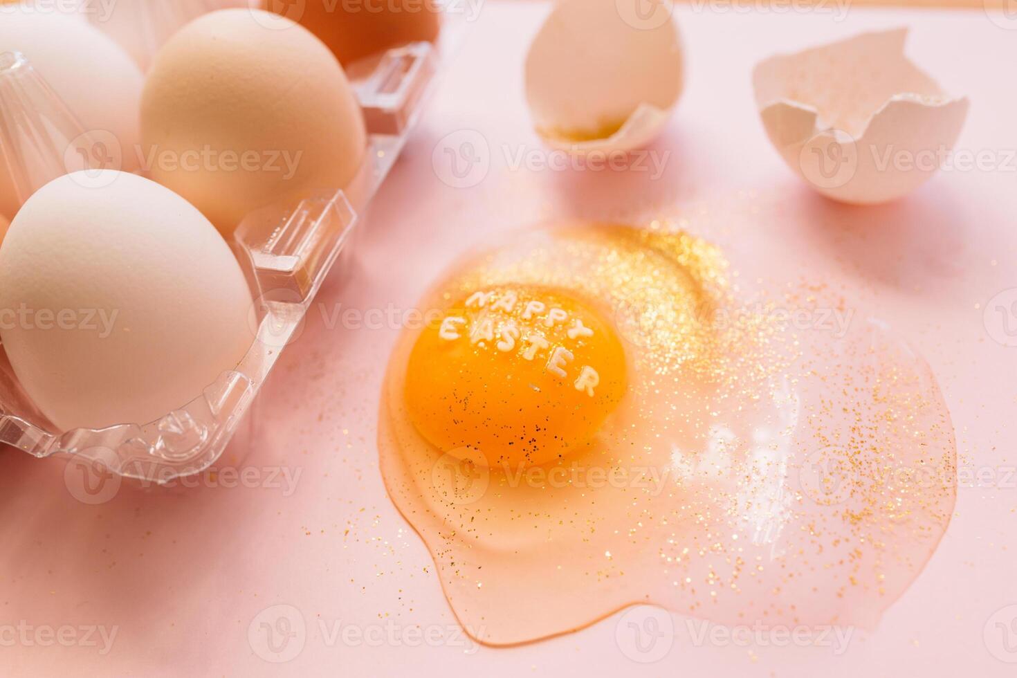 Festive Easter eggs in box and broken egg on table. photo
