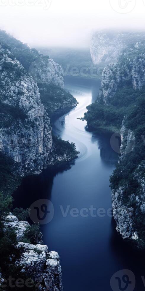 A river flowing through a gorge with trees and rocks photo