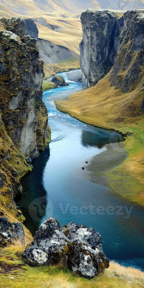 A river flowing through a valley with grass and rocks photo