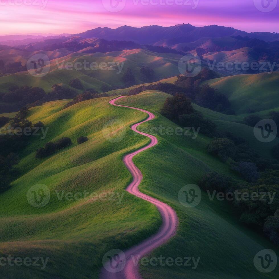 A winding road runs through a green valley photo