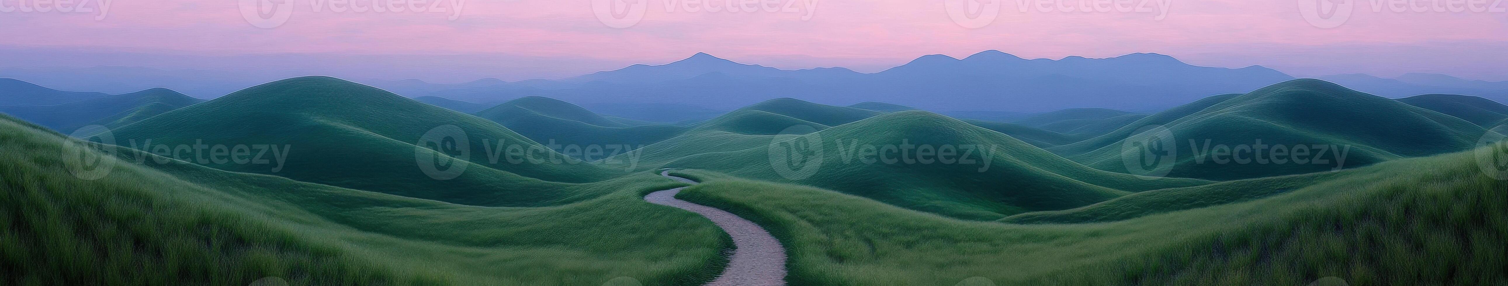 A winding path through green hills with mountains in the background photo