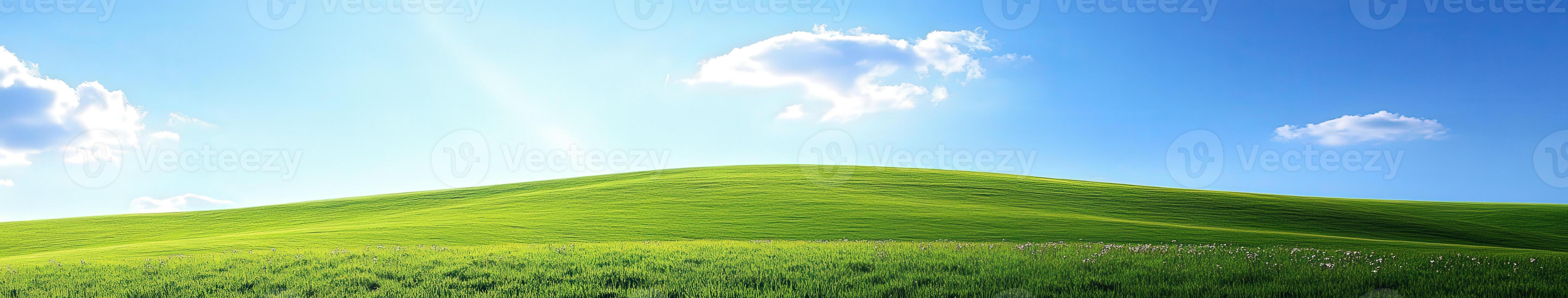 A green hill with blue sky and clouds photo