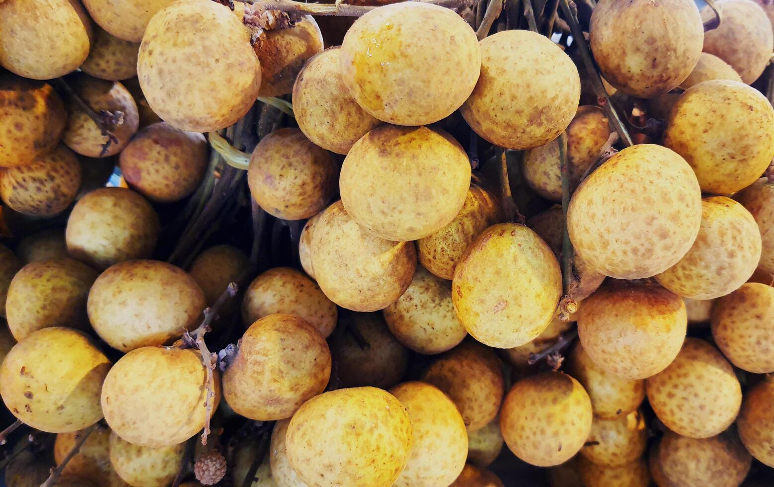 Longans for sale in supermarket, Fresh Longans background, tropical Thai fruit, Food available to everyone. photo