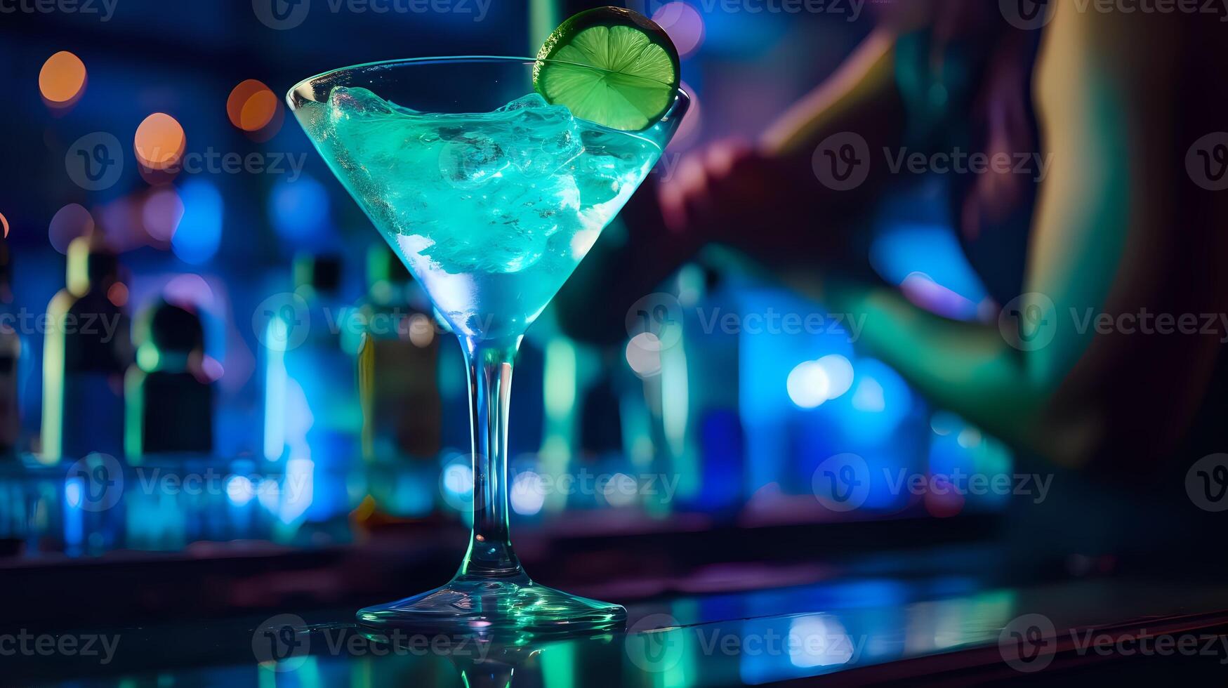 A refreshing blue cocktail garnished with a lime wedge sits on a photo