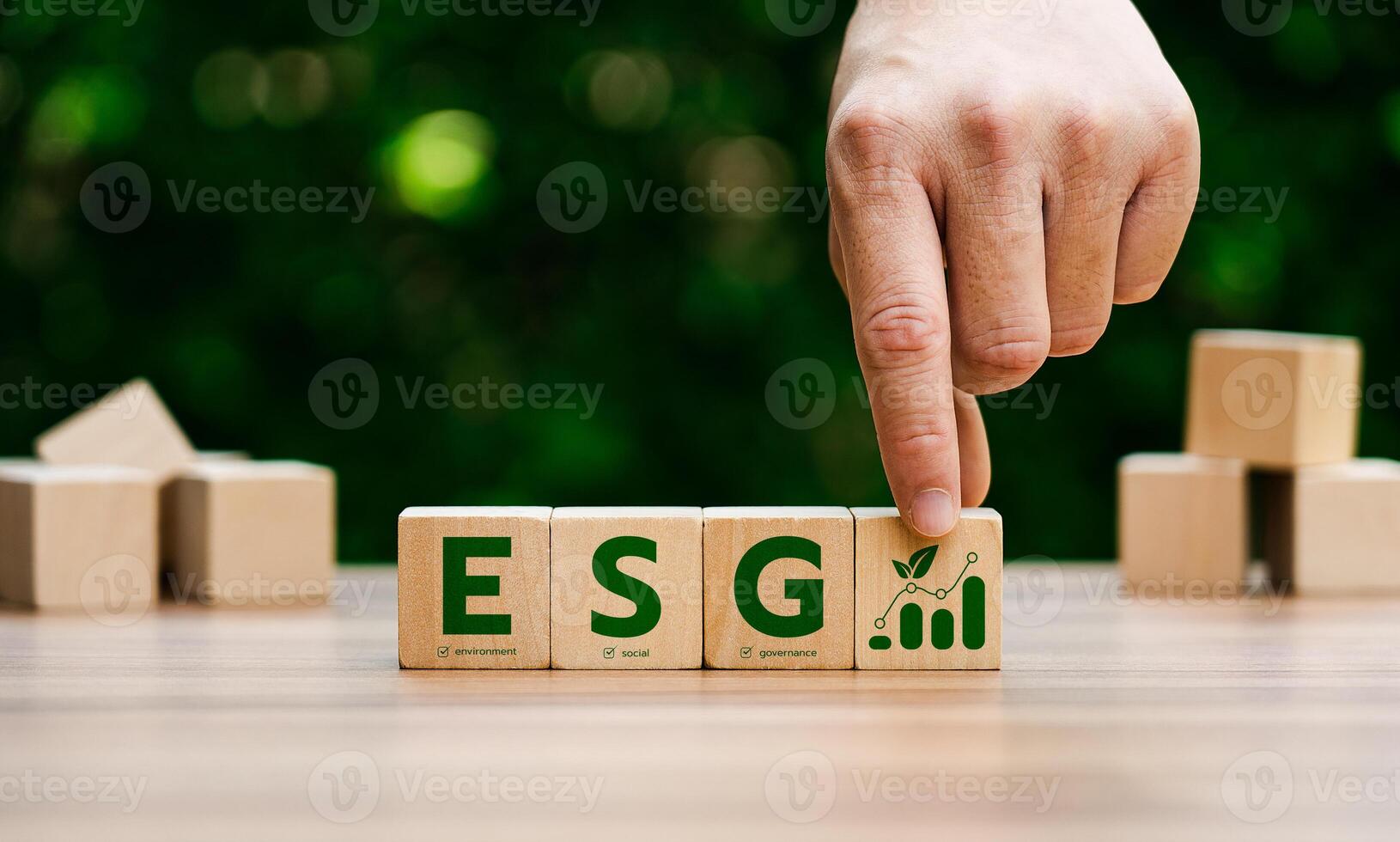 Hand arranging wooden blocks with ESG letters, representing environmental, social, governance principles, emphasizing sustainable business growth, corporate responsibility, ethical investment. photo