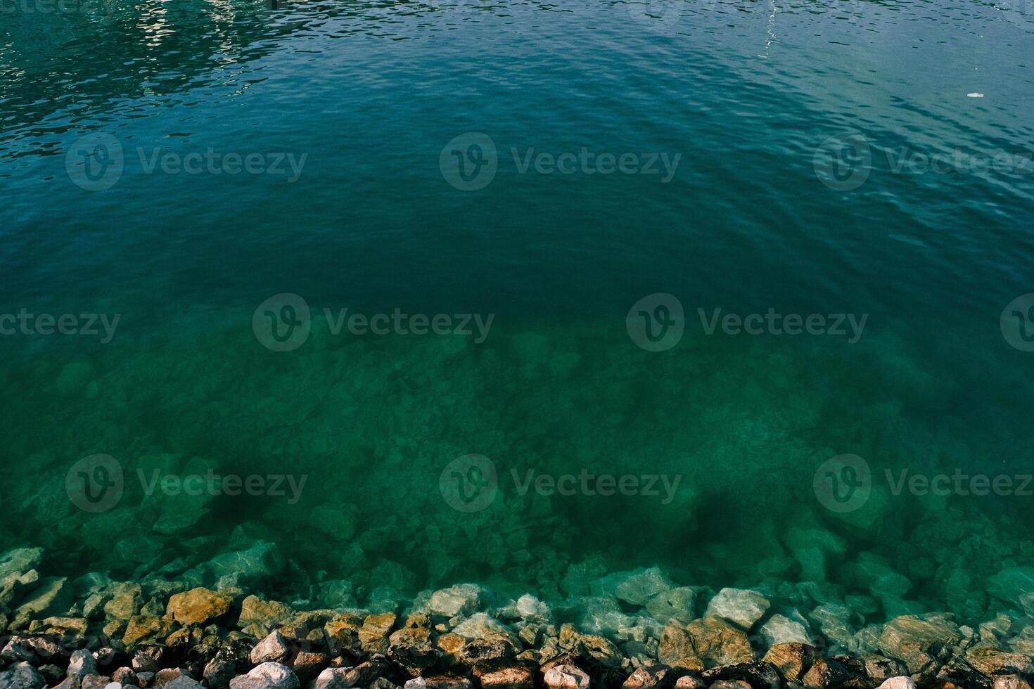 Stony bottom in clear sea water photo