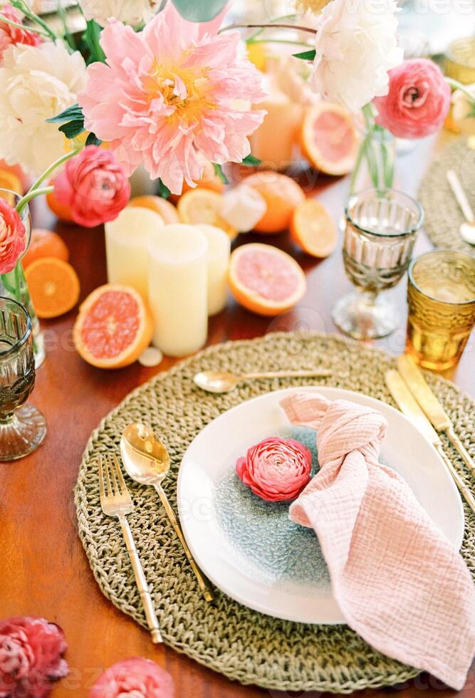 Knotted napkin lies on a plate next to a flower on a mat on a festive table photo