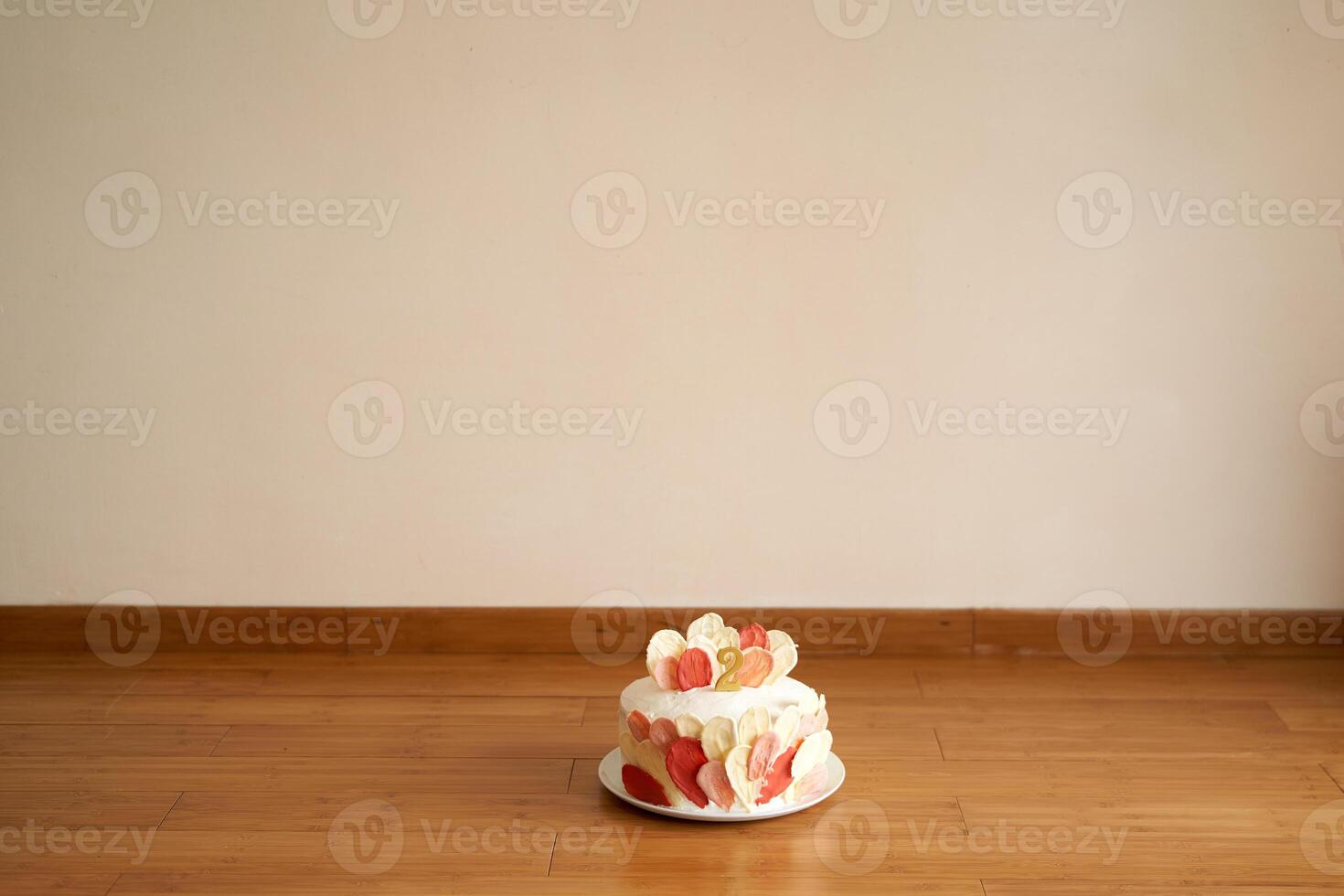 Chocolate cake with cherries and cream cheese for a children birthday stands on the floor in the room photo