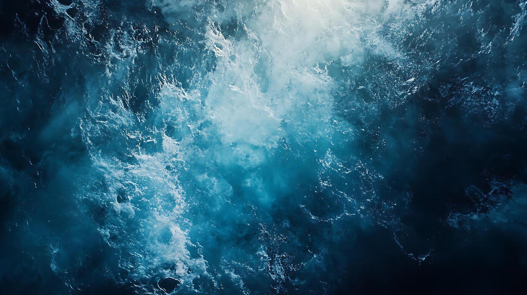 Aerial view of the ocean showcasing turbulent surface with shades of blue and white textured waves and splashing patterns photo