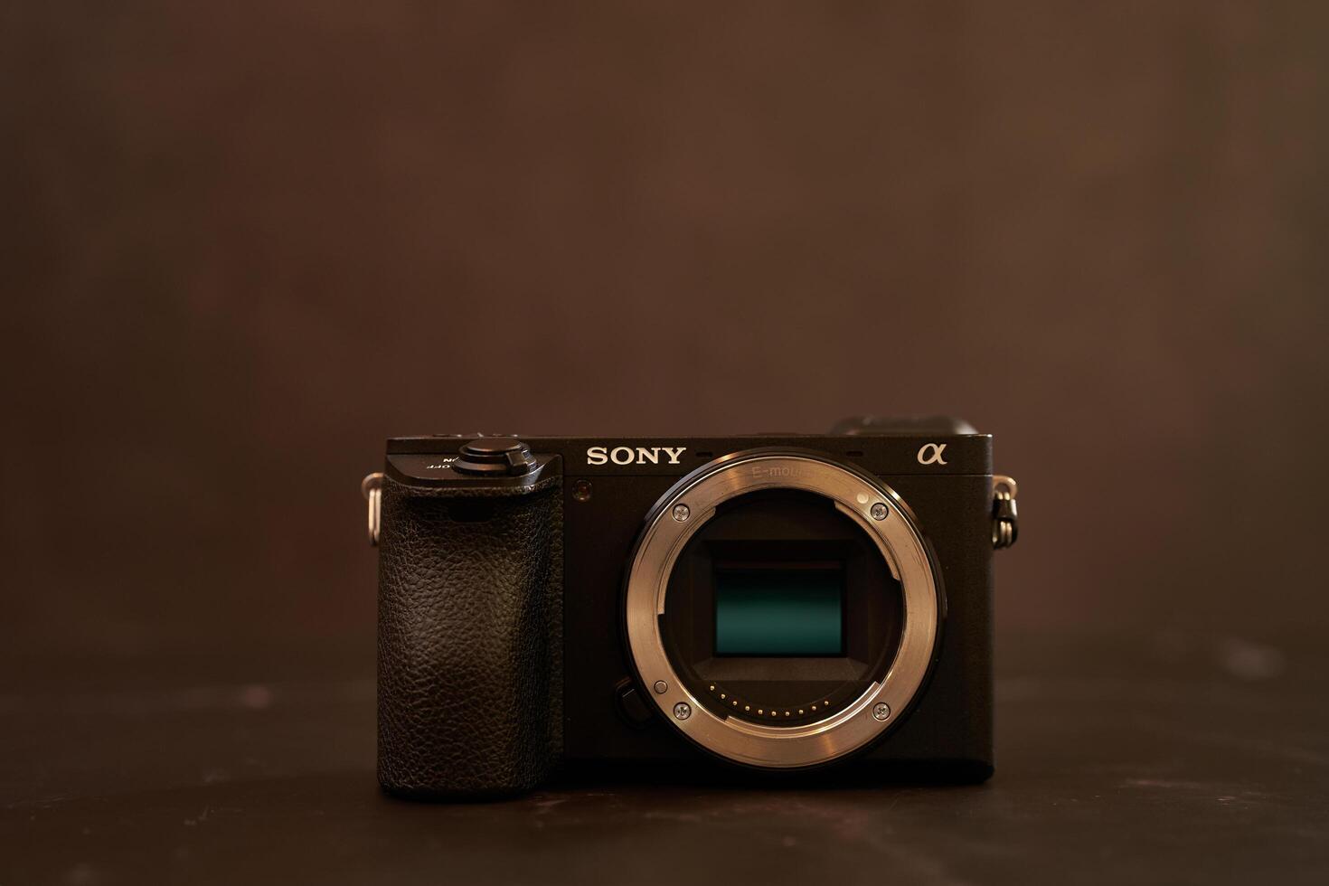 USA, Arizona - March 10, 2025. Sony A6500 mirrorless camera body stands on a black table photo