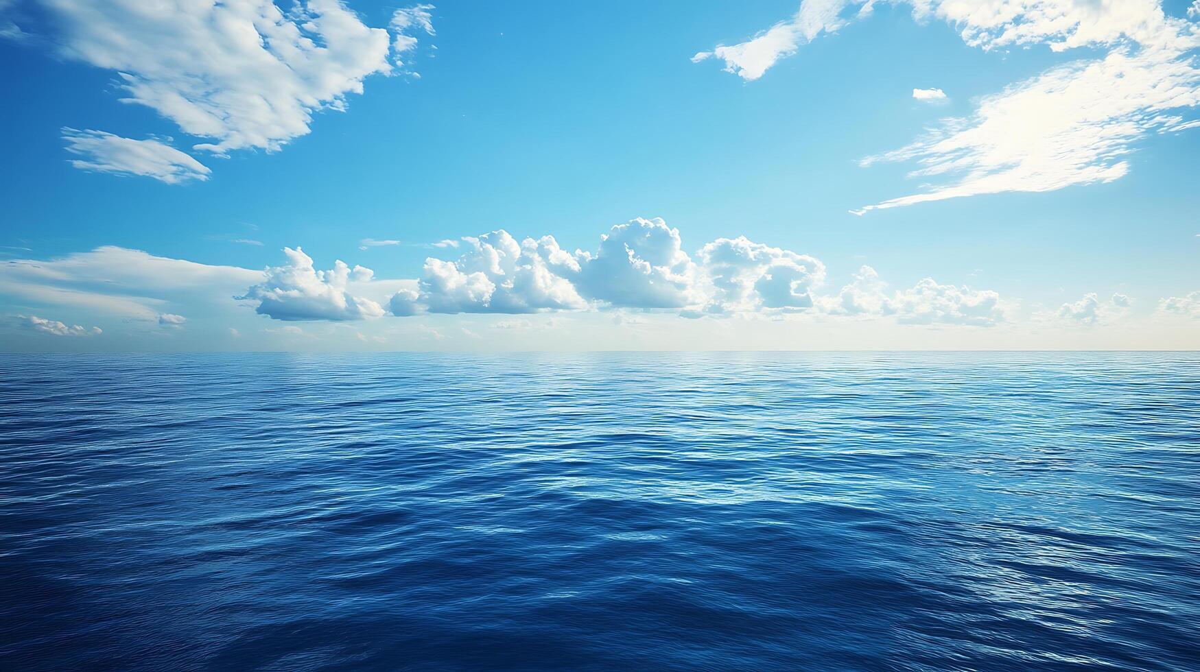A serene expanse of blue ocean stretches to the horizon beneath a clear partly cloudy sky evoking a sense of calm photo