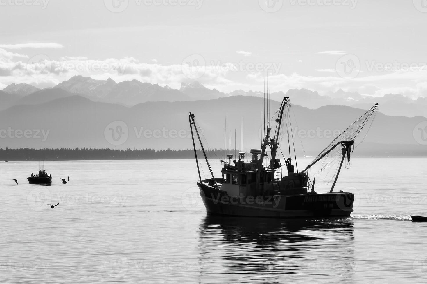 A fishing boat sails on the water with the mountains in the background on a serene day. photo