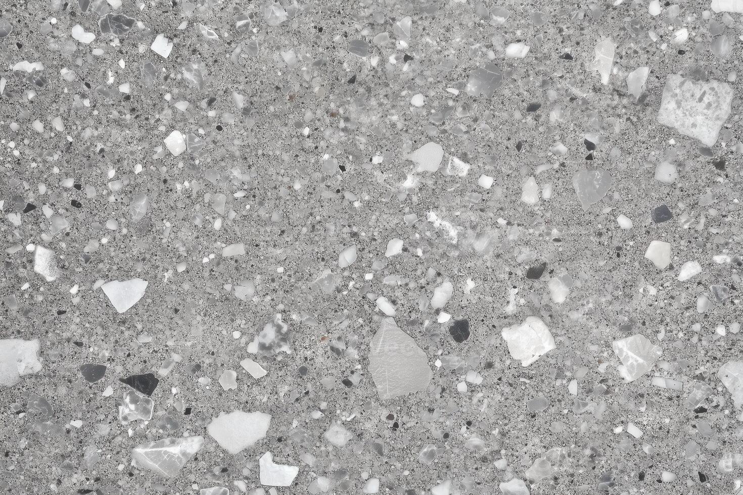 Gray terrazzo flooring surface featuring fragments of stone and providing a seamless decorative texture. photo
