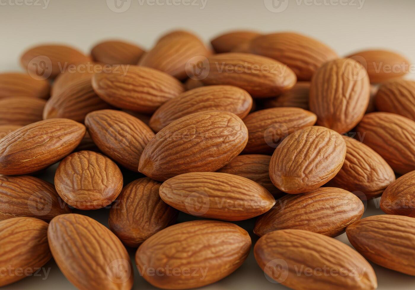 A tightly arranged pile of shelled almonds showcases their warm, inviting texture and wholesome appeal. photo