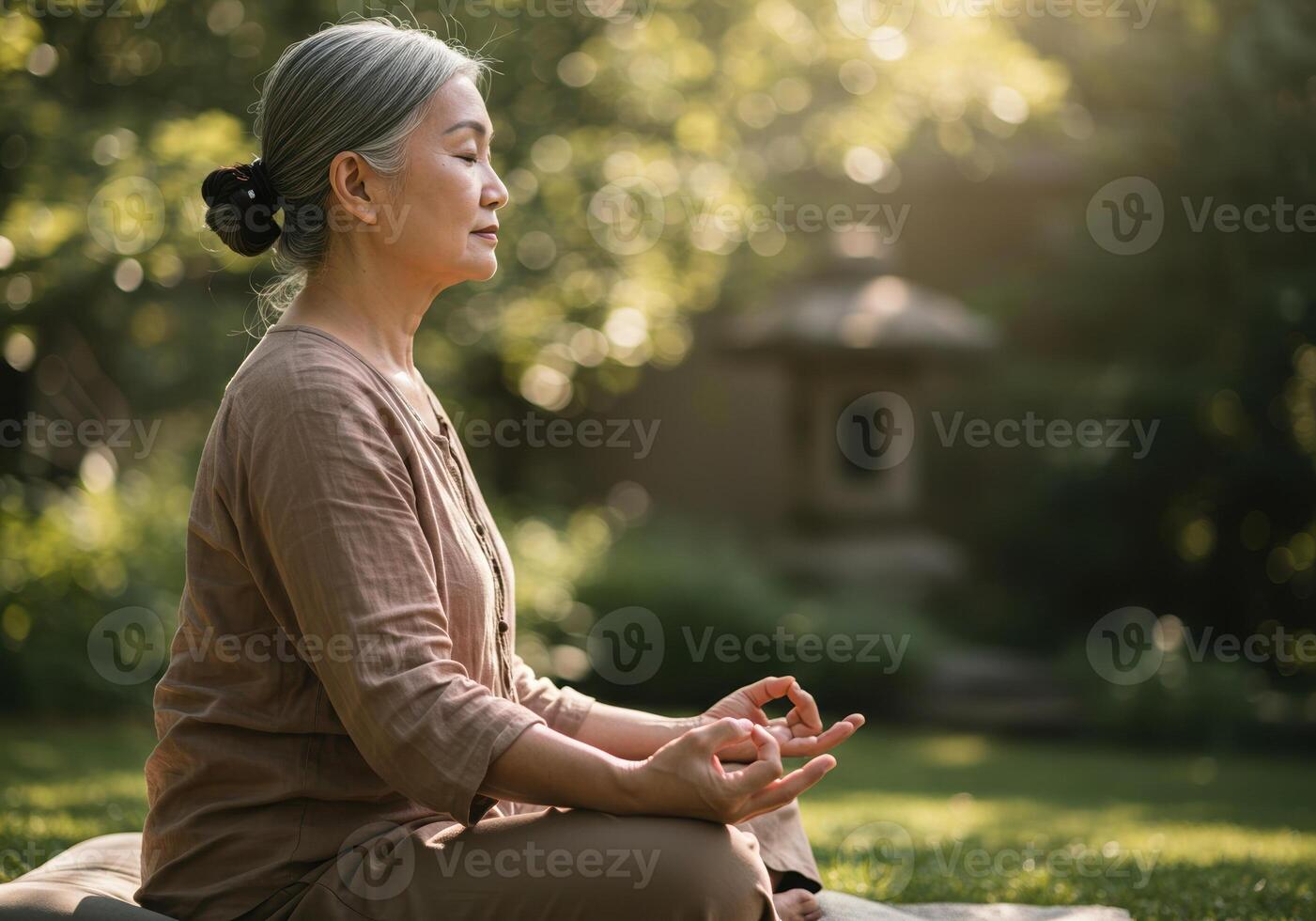 Mature woman meditates peacefully in a serene garden, finding inner peace and balance in nature. photo