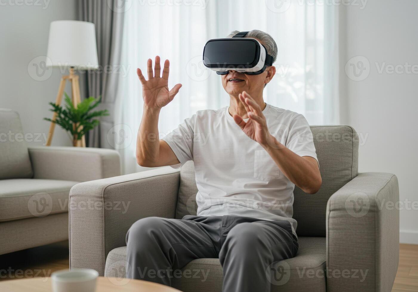 An Asian senior man enjoys a virtual reality experience in the comfort of his living room, using a VR headset. photo