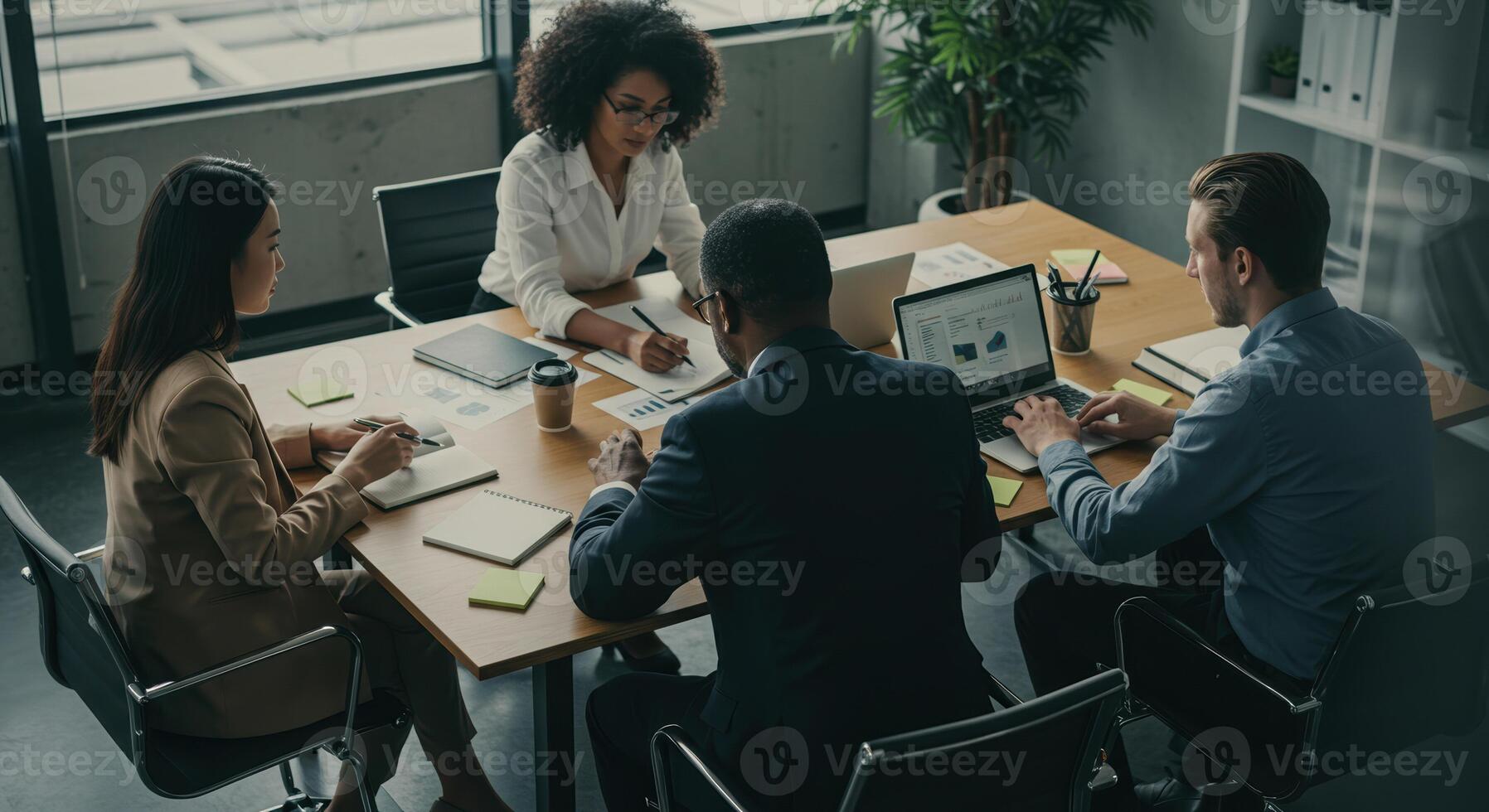 Diverse business team collaborates on financial analysis during a productive meeting in the office. photo