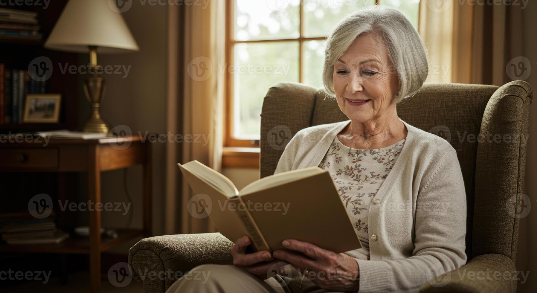 Senior woman sits in her armchair, immersed in a good book, enjoying a peaceful moment at home. photo