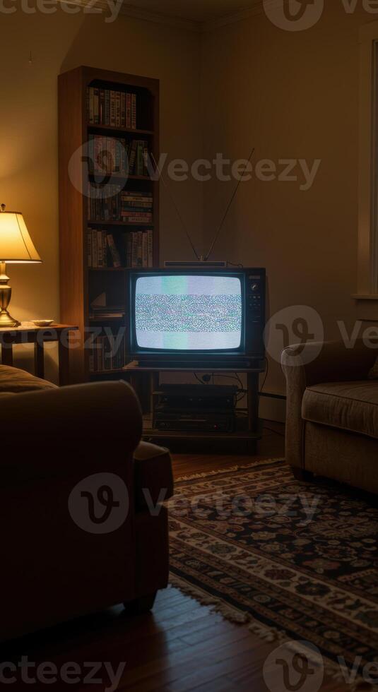 A vintage television displays static in a cozy living room at night. photo