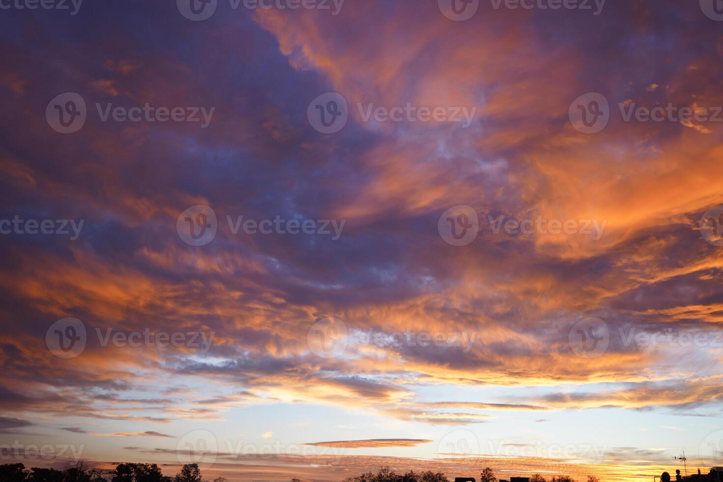 Fiery orange sunset sky with orange and red clouds near the sea. Beautiful sky. photo