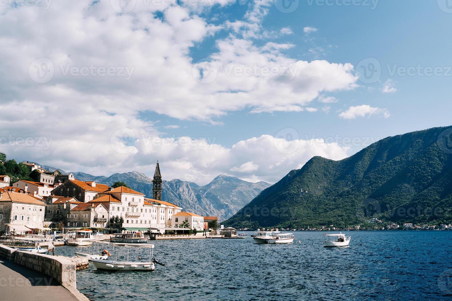 Many excursion boats with canopies are moored off the coast of Perast with views of the mountains. Montenegro photo