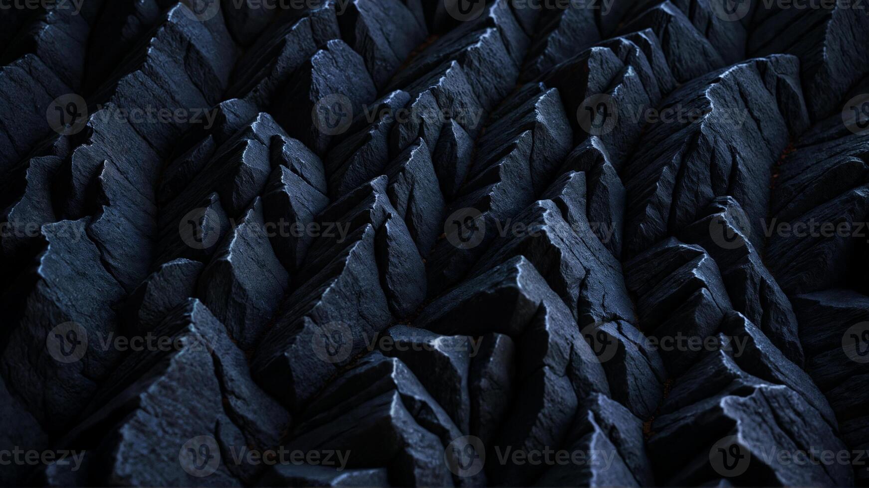 Close-up View of Sharp, Dark Textured Rock Formation in Shadows photo
